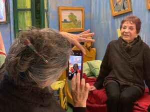 two women taking pictures in exhibit