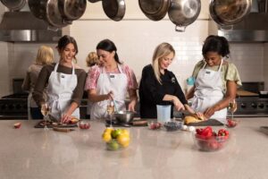 A group of women cooking at the Viking Cooking School.