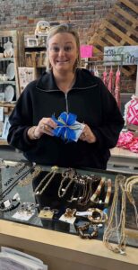 Casey holding an item with a blue bow